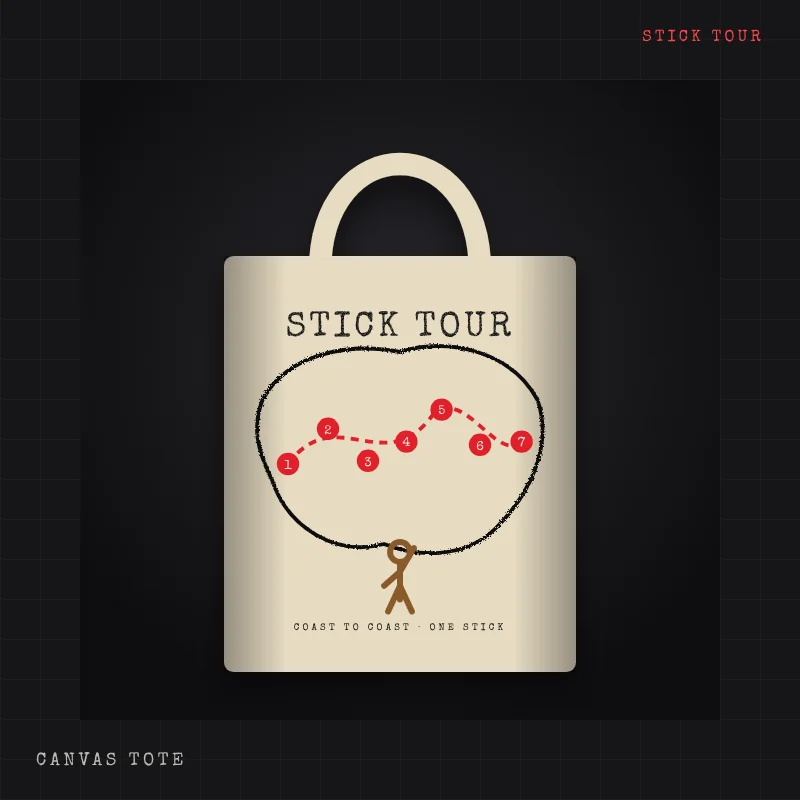 Natural canvas tote with a wooden stick man road-tripping across a hand-drawn United States map with seven numbered stops, titled STICK TOUR